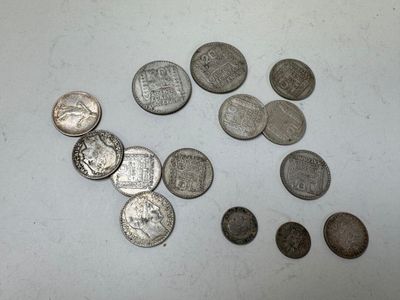 some coins are sitting on a table with a white background