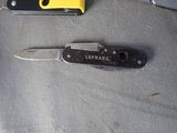 a small knife and a pocket knife on a table