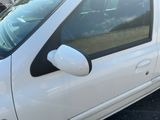 a white car parked in a parking lot with other cars in the background