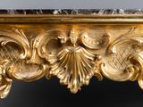 a gold frame with a mirror on it and a mirror on the wall