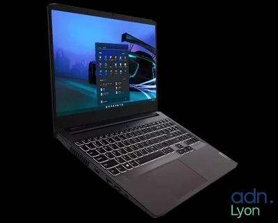 the laptop is open on a black background with a blue screen