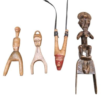 three wooden figurines are sitting next to each other on a white surface