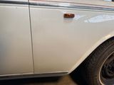 a white car with a red stripe parked in a garage