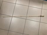 a stick on the floor of a public restroom