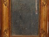 an old wooden frame with a mirror on top of it