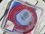 a red and blue cord that is on top of a white box