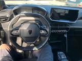 a man sitting in the driver ' s seat of a car