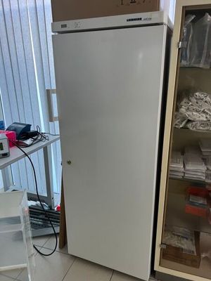 a white refrigerator in the corner of a room