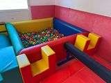 a ball pit in the corner of a room with a lot of balls in it