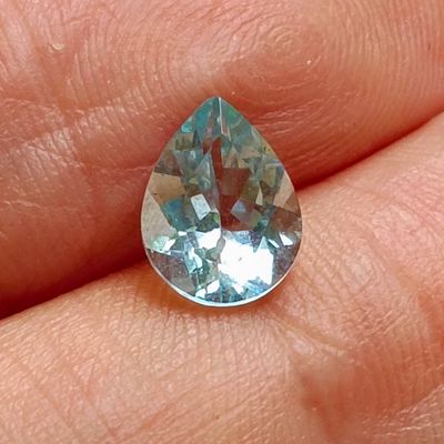 an image of a person holding a blue diamond in their hand