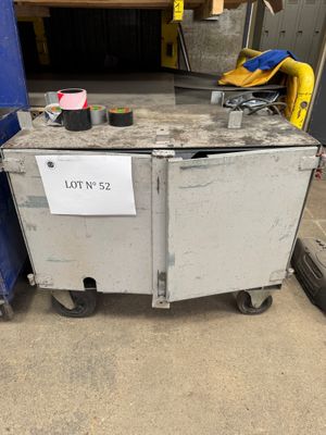 a metal box with a sign on it sitting in a garage
