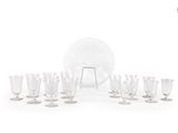 a lot of wine glasses and a plate on the table