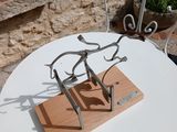 a small table with a metal sculpture on it