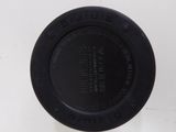 a white container with a black lid sitting on a table
