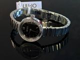 a watch that is sitting on a black table