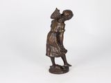 an old bronze statue of a woman with a cat on her shoulder