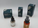 three bottles of liquid and a box of soap on a white surface