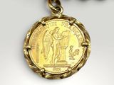 a close up of a gold necklace with a coin on it
