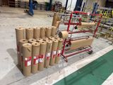 many rolls of brown paper on a cart in a warehouse