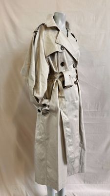 a woman ' s trench coat on a mannequin mannequin mannequin mannequin mannequin mannequin mannequin mannequin