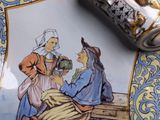 a plate with a picture of a man and a woman sitting at a table