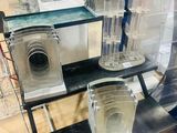 a glass display case with a pair of speakers on it