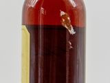 an image of a bottle of liquor sitting on top of a white surface