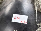 a black bottle with a sticker on it sitting in a pile of shredded paper