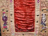 a red and gold cloth with a design on it