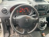dashboard of a small car with a steering wheel and dashboard gauges