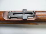 a close up of a rifle on a white surface
