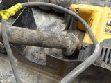 a yellow cord connected to a yellow and black drill