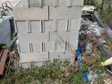 a pile of bricks sitting on the ground next to a building