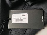 the back of a black jacket with a price tag on it