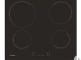 a black stove top with four burners on it