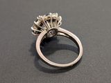 a close up of a diamond ring on a black surface