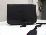 a black purse sitting on top of a white table