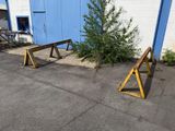 two wooden benches sitting in front of a blue building
