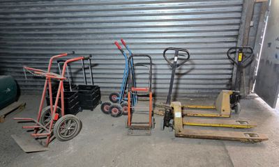 many different types of hand trucks in a garage