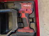 a red tool box with tools in it on the floor