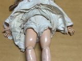 a doll that is laying down on the floor