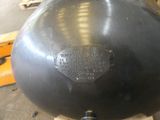 a large metal ball sitting on top of a wooden pallet