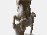 marble statue of a man sitting on a horse with a goat