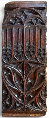 an old wooden panel with a design of leaves and flowers on it