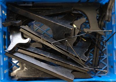 a blue crate filled with tools sitting on a table