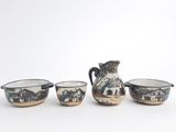three bowls and a pitcher sitting next to each other on a table