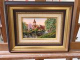 a picture of a painting of a church on a easel