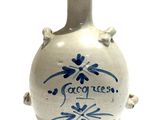 a white vase with a blue design on it