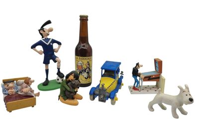toy figurines of a man, a dog, a bed, and a bottle of beer