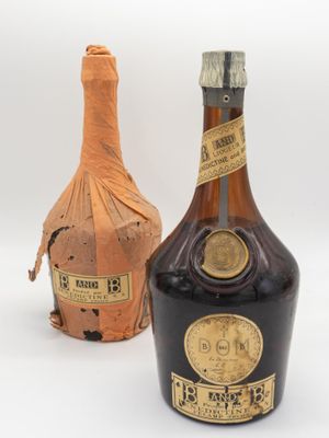 two bottles of liquor sitting next to each other on a white surface